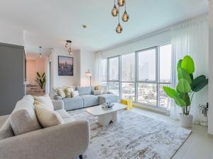 a living room with a couch and a table at the 'New York' Condo - 4BR Executive Burj Khalifa Suite in Dubai