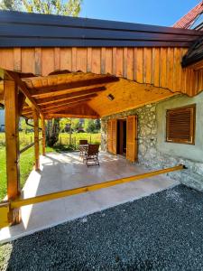 a wooden pergola on a patio of a house at Kuća za odmor Goranski mir in Mrkopalj