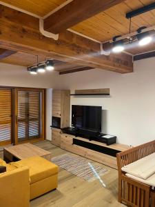 a living room with a large flat screen tv at Kuća za odmor Goranski mir in Mrkopalj