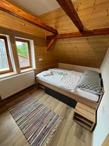 a bedroom with a bed in a wooden room at Kuća za odmor Goranski mir in Mrkopalj