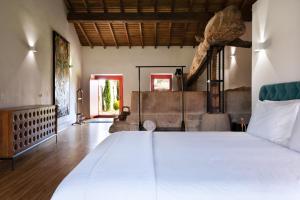 a bedroom with a large white bed in a room at Casa Dr Ramiro Salgado - Douro Superior, Torre de Moncorvo in Torre de Moncorvo