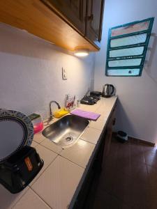 a kitchen with a sink and a counter top at Posada KUARAHY in Puerto Iguazú +56 photos
