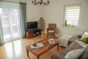 a living room with a couch and a coffee table at Ferienwohnung Zentral in Langenargen