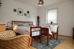 a bedroom with a bed and a table and chairs at Ferienwohnung Zentral in Langenargen