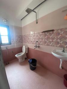 a bathroom with a toilet and a sink at Southern Cliff House in Varkala