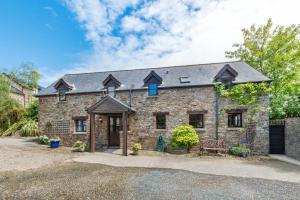 an exterior view of a stone house at 4 Bed in Westward Ho oc-n1623 in Westward Ho