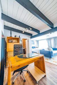 a desk and a chair in a room with a bed at Baja Beach House Pools, Beaches & Ocean View in San Antonio del Mar