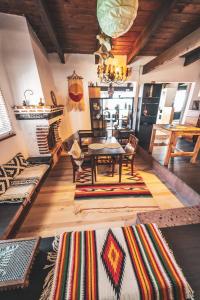 a living room with a table and a bunch of rugs at Baja Beach House Pools, Beaches & Ocean View in San Antonio del Mar