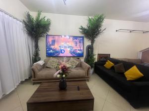 a living room with two couches and a coffee table at Sahara View Guest House Prime Location on the Dubai Sharjah Border in Sharjah