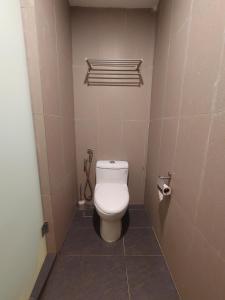 a small bathroom with a toilet in a stall at Sofea Roomstay Hotel in Kota Bharu
