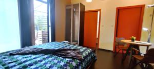 a bedroom with a bed and a table with chairs at B&B Casa de Paja in Sint-Truiden +18 photos