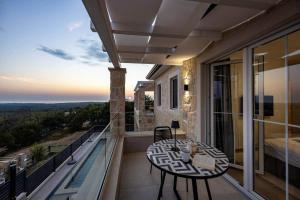 a balcony with a table and chairs on a balcony at Villa Bella Vista with Pool and Seaview in Labinci