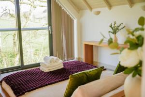 a room with a couch and a window with towels at Oak Lodge in Knighton