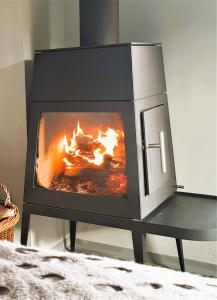 a fireplace in a living room with flames in it at Weinloft III by Weinlofts in Eisenberg an der Pinka +16 photos
