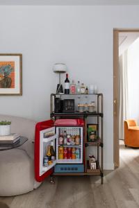 an open refrigerator in a living room next to a couch at Virgin Hotels Edinburgh in Edinburgh +66 photos