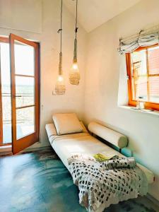 a room with a bed and a window at Weinloft III by Weinlofts in Eisenberg an der Pinka
