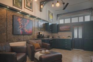 a living room with a couch and chairs and a kitchen at Arena Apartment Meadowhall in Brightside