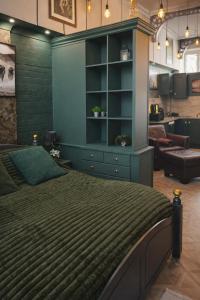 a bedroom with a bed and a blue cabinet at Arena Apartment Meadowhall in Brightside