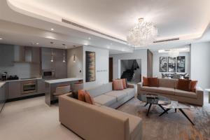 a living room with a couch and a table at Radisson Collection Residences, Riyadh in Riyadh