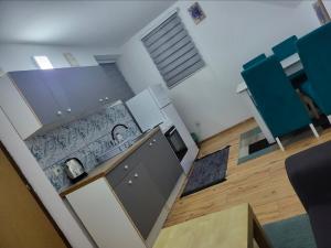 an overhead view of a kitchen with blue chairs at Lira Apartmani in Prnjavor +18 photos