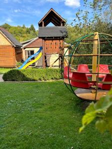 a playground with a slide in a yard at Country House Liptov in Svätý Kríž