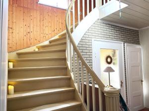a spiral staircase in a home with a white door at Villa Seenswert in Lauta +25 photos