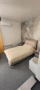 a bedroom with a large bed in a room at Антарес Отель in Shemonaīkha