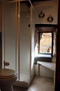 a bathroom with a shower with a toilet and a window at Casa Margherita in Bolsena