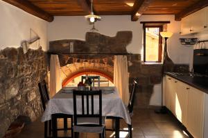 a dining room with a table and a brick oven at Casa Margherita in Bolsena