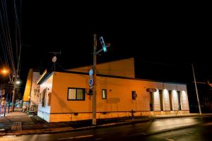 a building on the corner of a street at night at ステラガーデン in Kami-furano