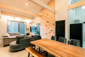 a living room with a table and chairs at ステラガーデン in Kami-furano