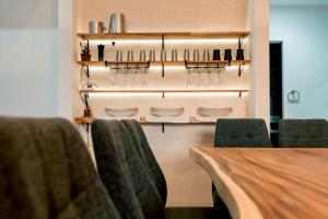 a dining room with a table and chairs and wine glasses at ステラガーデン in Kami-furano +45 photos