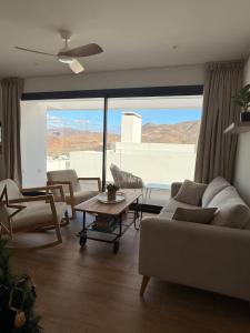 a living room with a couch and a table at Casa Almar in San José +44 photos