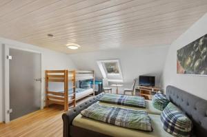 a bedroom with a couch and a bunk bed at Haus am Scheibenfelsen in St. Blasien +24 photos