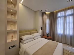 a bedroom with a large bed and a window at The Grand Elite Cairo Hotel in Cairo