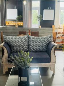 a couch sitting in a living room with a table at Naadee villa in Ekala