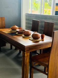 a wooden table with brown bowls on top of it at Naadee villa in Ekala +13 photos