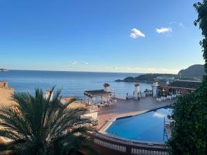 a view of the ocean from a resort with a swimming pool at Aldea 2 Cala Fornells in Paguera