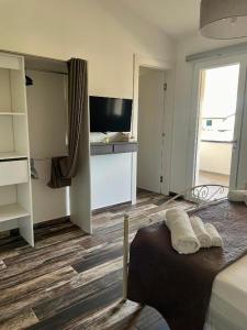 a bedroom with a bed and a television in a room at B&B Helios in Nardò