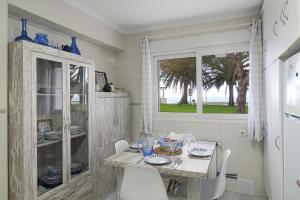 ein Esszimmer mit Tisch und Stühlen und einem Fenster in der Unterkunft Comillas playa in Comillas + 9 Fotos