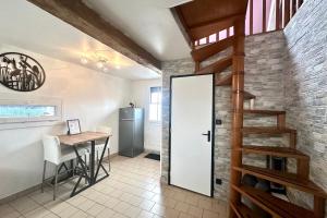 a kitchen and dining room with a staircase and a table at Escapade détente Duplex cosy avec SPA Parking in Abbeville