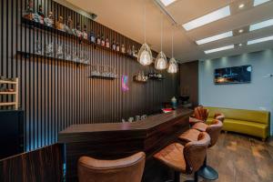 a bar in a restaurant with stools and a counter at Ramada by Wyndham Frankfurt Central Station in Frankfurt