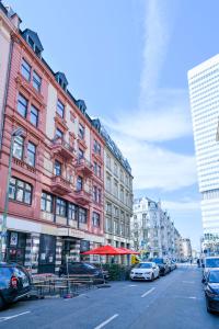 a group of buildings on a city street with cars at Ramada by Wyndham Frankfurt Central Station in Frankfurt