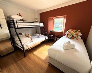 a bedroom with two bunk beds and a window at Westport Rooms in Westport