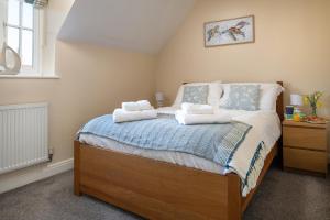 a bedroom with a bed with towels on it at Sandy Toes, The Bay, Filey in Filey +54 photos