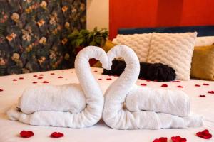 two towels shaped like swans sitting on a bed at 1 Bed Flat - Sleeps 5 - Pet friendly - Parking in South Shields
