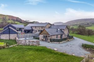 an aerial view of a stone house with a driveway at Y Stabl The Stable in Oswestry
