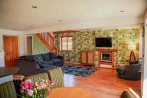 a living room with a couch and a fireplace at Willow Lodge in Knighton