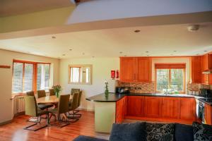 a kitchen with a table and some chairs in a room at Willow Lodge in Knighton