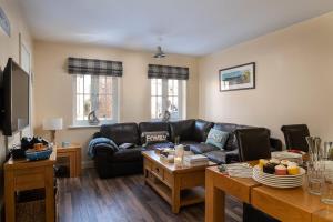 a living room with a couch and a table at Sandy Toes, The Bay, Filey in Filey